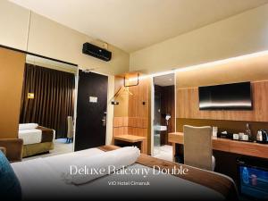 a hotel room with a bed and a bathroom at Vio Hotel Cimanuk Bandung in Bandung