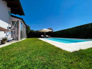 a swimming pool in a yard next to a house at Sonomusica B&B in Gazzola Di Rivalta