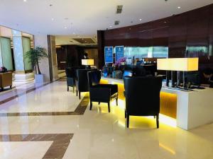 a lobby with chairs and a bar in a building at The Imperial Mansion, Beijing - Marriott Executive Apartments in Beijing +50 photos