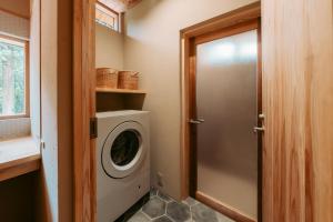 a laundry room with a washing machine and a door at inishie in Nishinoomote