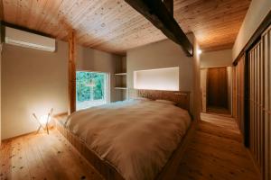a bedroom with a bed in a room with a window at inishie in Nishinoomote +14 photos