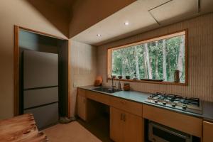 a kitchen with a sink and a window at inishie in Nishinoomote