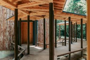 a wooden pavilion in a forest with a window at inishie in Nishinoomote