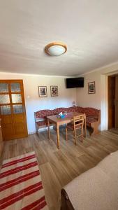 a living room with a table and a couch at Apartmán AZ in Prostřední Bečva