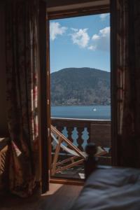 a bedroom with a view of the water from a window at Superseegarten in Bad Wiessee