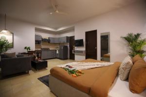 a bedroom with a large bed and a living room at BedChambers Serviced Apartments, Sushant Lok in Gurgaon