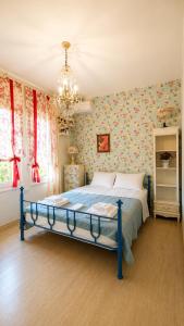 a bedroom with a blue bed with floral wallpaper at Villa AVRA in Drama +28 photos