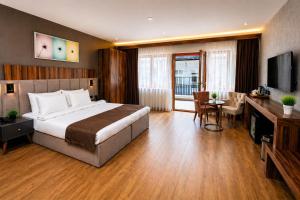 a hotel room with a large bed and a desk at Vita Suites Karaköy in Istanbul