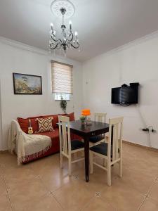 a living room with a table and a couch at Valentino Apartments in Shkodër