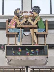 a painting of two people sitting at a table at Le Petit Talensac in Nantes