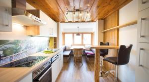 a kitchen with a table and a dining room at Ringlerhof in Michaelerberg