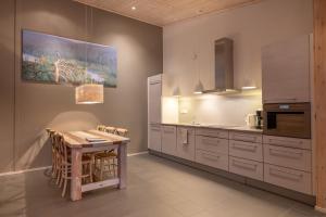 a kitchen with a wooden table and a dining room at Sallainen Panvillage in Salla
