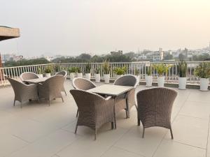 a row of tables and chairs on a balcony at Ek Tara Guest House in Udaipur