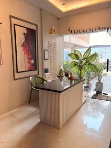 a lobby with a counter and a chair in a room at Ek Tara Guest House in Udaipur