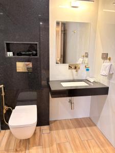 a bathroom with a white toilet and a sink at Ek Tara Guest House in Udaipur +10 photos