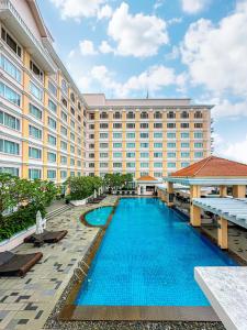 a large hotel with a large pool in front of it at Equatorial Ho Chi Minh City in Ho Chi Minh City