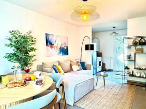 a living room with a couch and a table at Charming Tournefeuille House in Tournefeuille