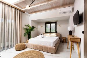 a bedroom with a large bed and a couch at The Four Villas Hanioti by Luxlikehome in Hanioti +274 photos