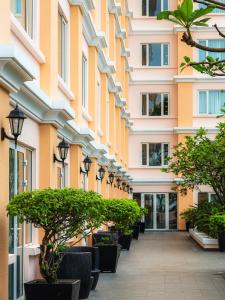 a corridor of a building with potted plants at Equatorial Ho Chi Minh City in Ho Chi Minh City