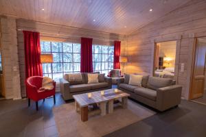 a living room with a couch and a table at Sallainen Panvillage in Salla