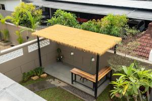 a small house with a bench and a roof at Gumitish Residence Singaraja in Singaraja +35 photos