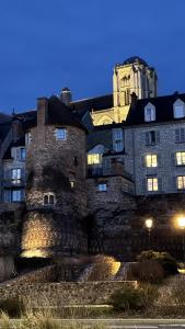 a large stone building with a tower in the background at Maison Saint Christophe in Le Mans