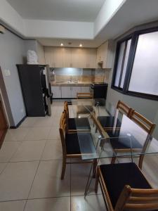 a kitchen with a table and chairs and a refrigerator at Ralph Anthony Suites Hotel in Manila