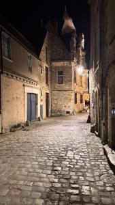 an empty cobblestone street in an old town at night at Maison Saint Christophe in Le Mans +44 photos