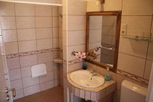 a bathroom with a sink and a mirror and a toilet at Diófa Vendégház in Bükkszék +10 photos