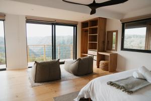 a bedroom with a bed and a large window at Ocean's Edge - Private Nature Reserve in George