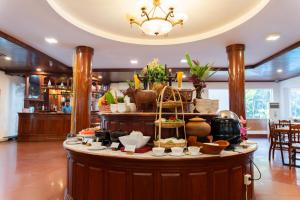 a buffet in a restaurant with dishes on a table at YASODHARAPURA Residence in Siem Reap