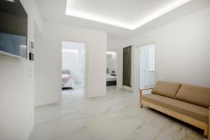 a living room with a couch and a bedroom at GuestHost - Lume di Mare in Faccia di Trippa