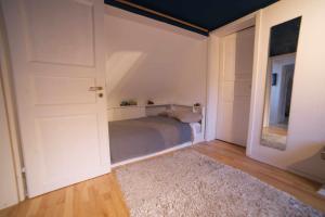 a bedroom with a bed and a door with a rug at Haus im Rübental in Bad Dürkheim +15 photos