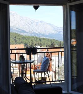 a room with a balcony with a view of a mountain at Seba Apartments in Korčula