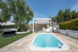 a swimming pool in a yard with a gazebo at GuestHost - Lume di Mare in Faccia di Trippa