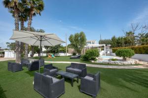 a patio with a table and chairs and an umbrella at GuestHost - Lume di Mare in Faccia di Trippa