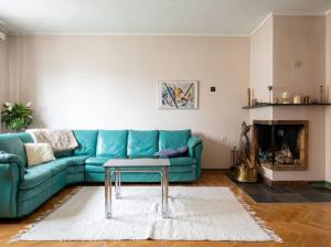 a living room with a blue couch and a table at JS10 - 2BR Central Bergen Views in Bergen