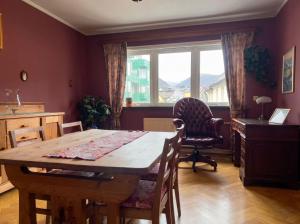 a dining room with a table and a chair and a window at JS10 - 2BR Central Bergen Views in Bergen
