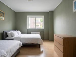 a bedroom with two beds and a window at JS10 - 2BR Central Bergen Views in Bergen +8 photos