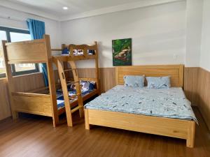 a bedroom with two bunk beds and a ladder at Villa 1985 in Buon Ma Thuot