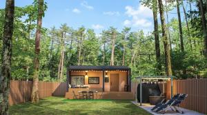a tiny house in the woods with a backyard at Fuji Fumoto Forest Onsen ふじ ふもとの森温泉 in Fujikawaguchiko