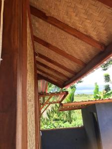 a view of the ocean from a room with a window at Konbayan Forest Stay in Bayan
