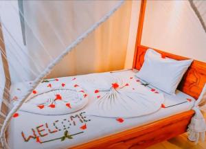 a bed with two pillows with the words happy new year at 27Azmaa hotel & safaris in Zanzibar City
