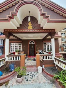 a house with a front porch with a door at Om Raghav Homestay in Kathmandu