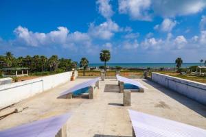 a skate park with benches and the ocean in the background at Jo Inn Beach View Guest House in Kuilapayam