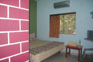 Postel nebo postele na pokoji v ubytování Hotel Anjali Lodge Malvan