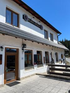 a building with a sign on the side of it at Zlatá Stezka in Modrava +5 photos