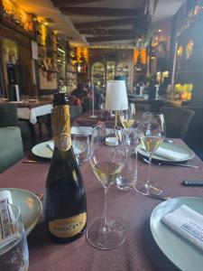 a bottle of wine sitting on a table with glasses at Rooms&Rest ПИРОЋЋ Heritage in Pirot