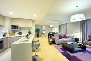a large living room with a kitchen and a living room at Somerset Heping Shenyang in Shenyang