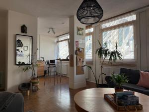 a living room with a couch and a table at St Catherine - Sweet home - Bxl - Studio Apartment with city view in Brussels